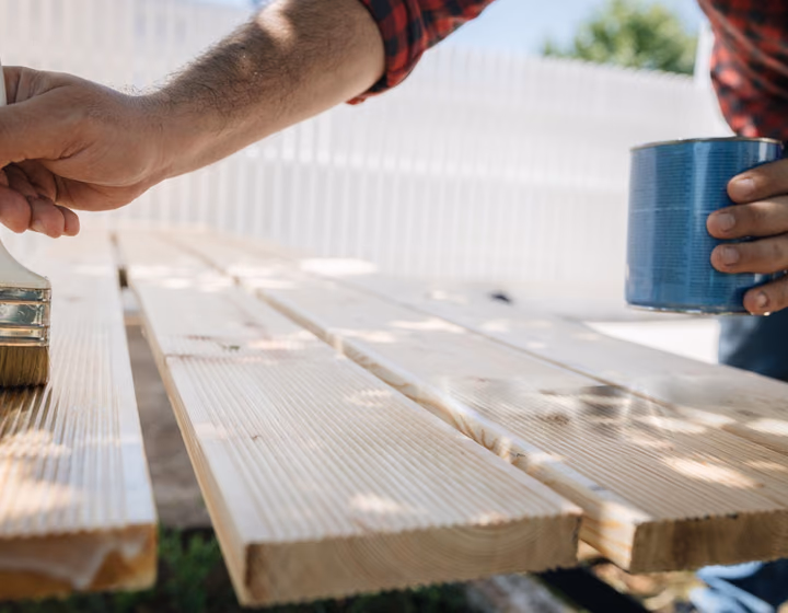 Staining a treated pine deck board by hand