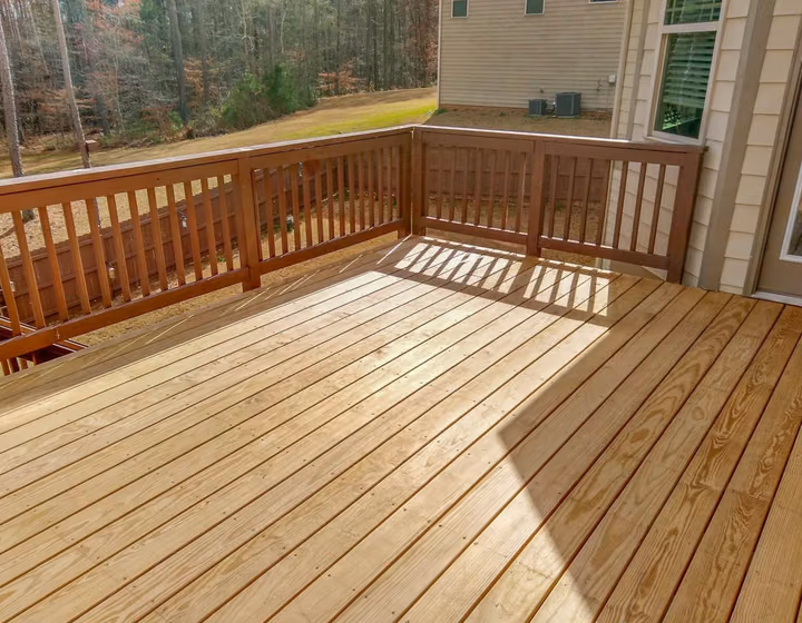 A stained timber deck bordered by a timber balustrade